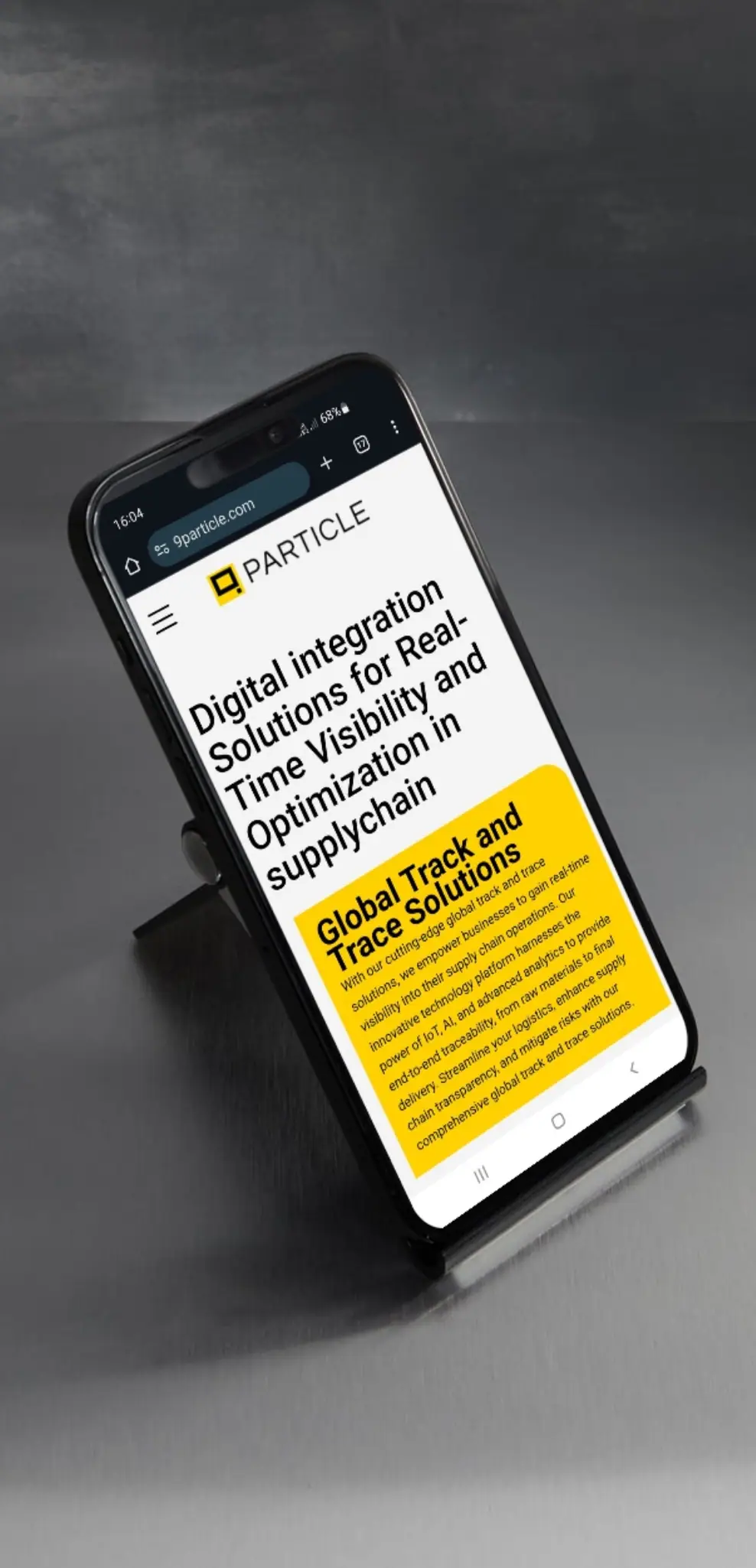 9Particle homepage rendered responsively on a mobile phone in a stand