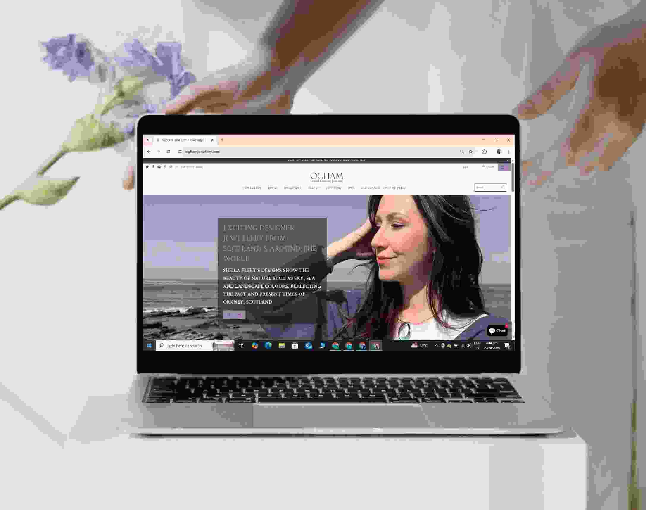 Ogham Jewellery homepage hero with a Scottish designer collection banner, shown on a laptop
